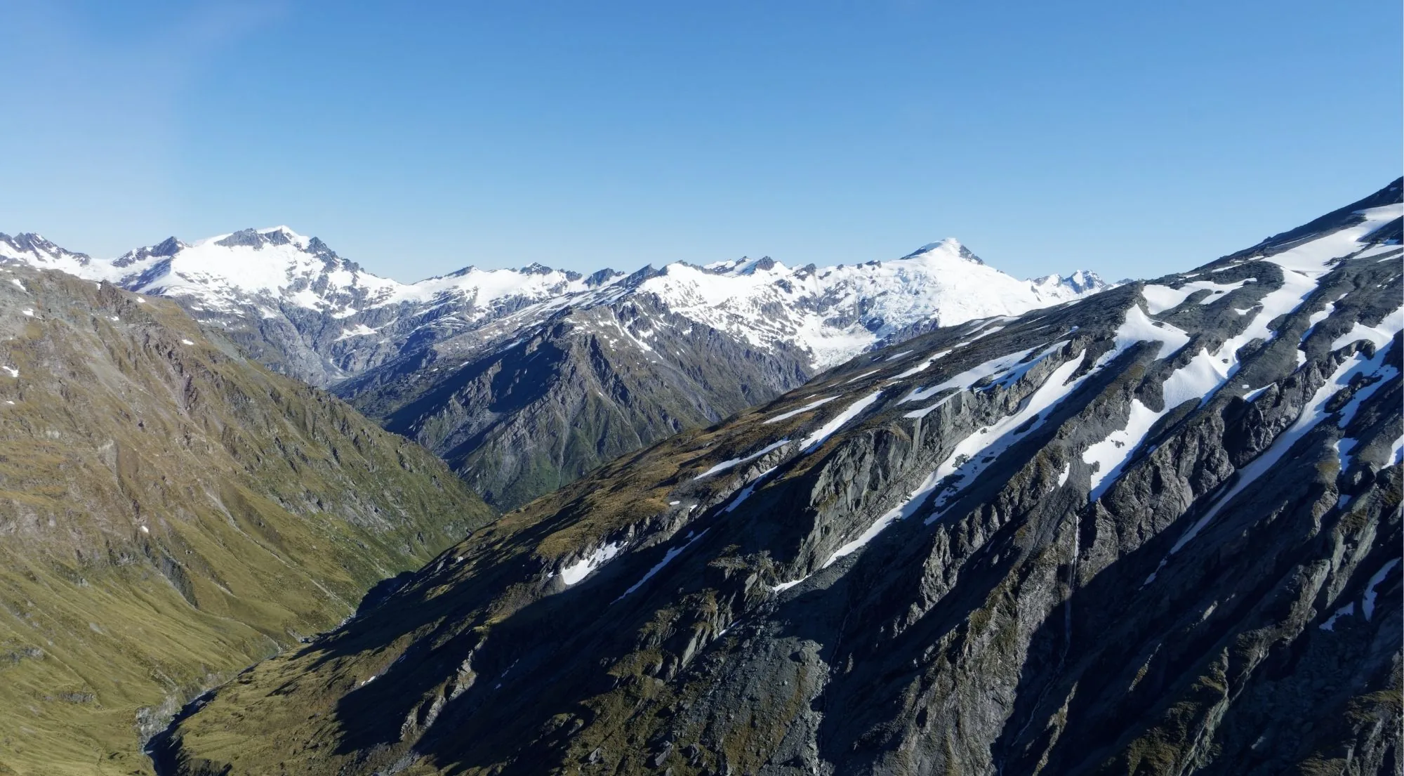 Hanging valley falling away between snow-capped ranges of the Southern Alps, seen from the air