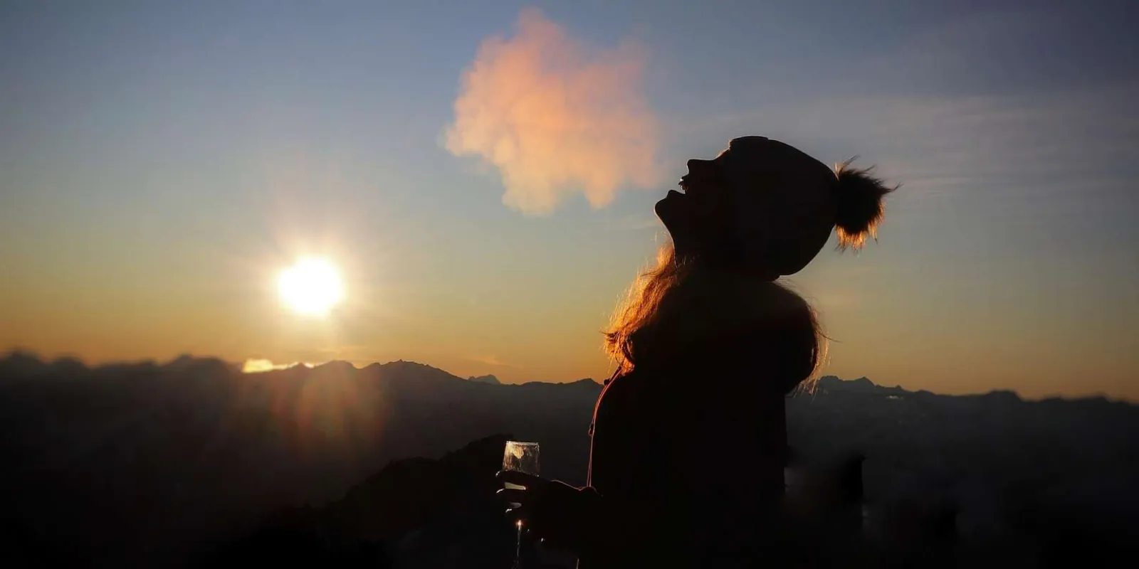 Guest silhouetted against the setting sun at the alpine landing site