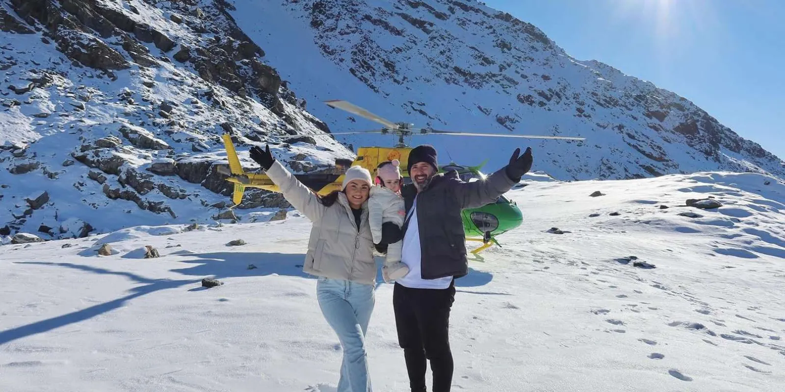 Two guests larking about in the snow at the alpine landing site